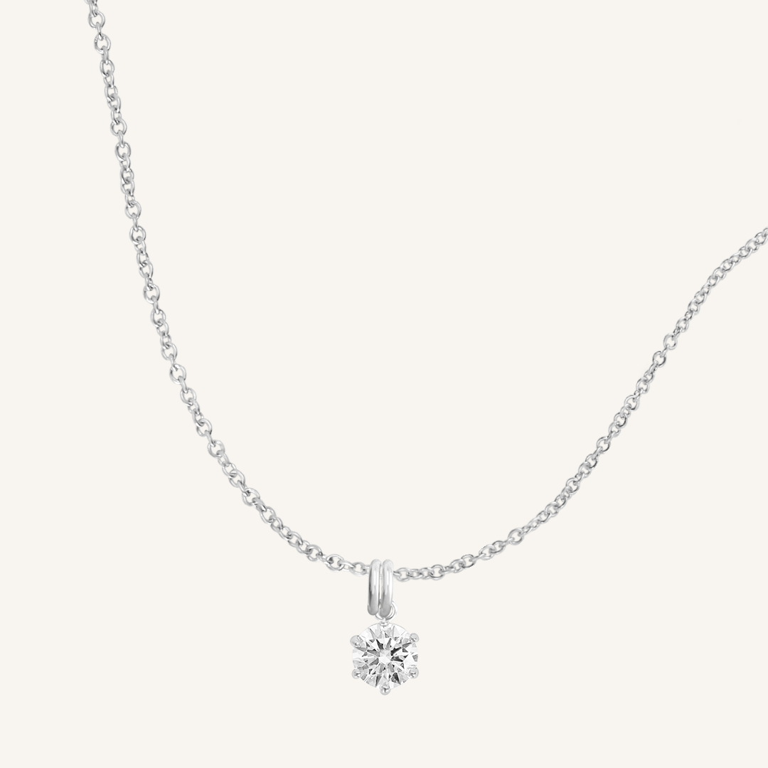 Round, silver, cubic zirconia charm on gold chain