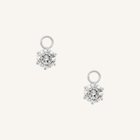 A set of two hoop charms with silver metal tone, designed to be attached to earrings.