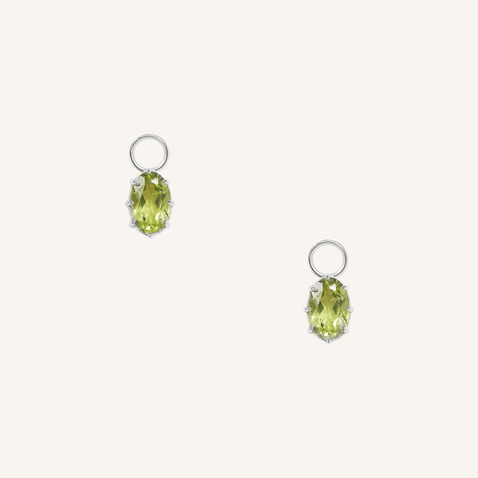 A set of two silver hoop charms with olive green stones, isolated on a white background.