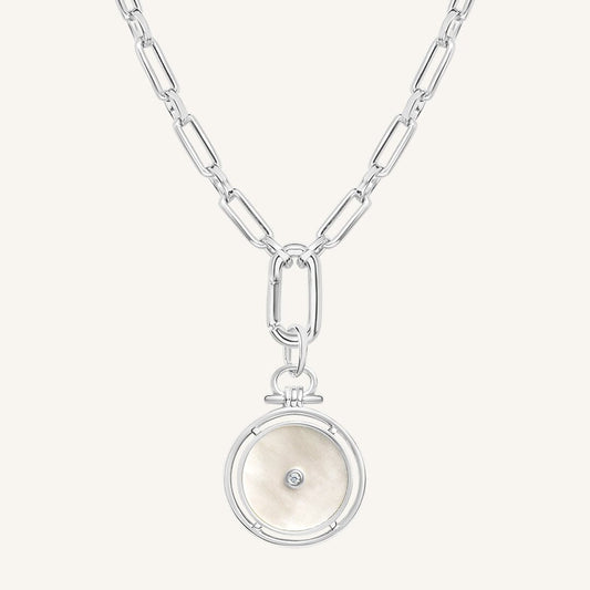 Silver necklace with a round pendant on a white background