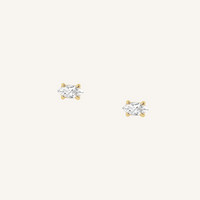 A pair of stud earrings with clear cubic zirconia set in gold metal, presented against a white background.