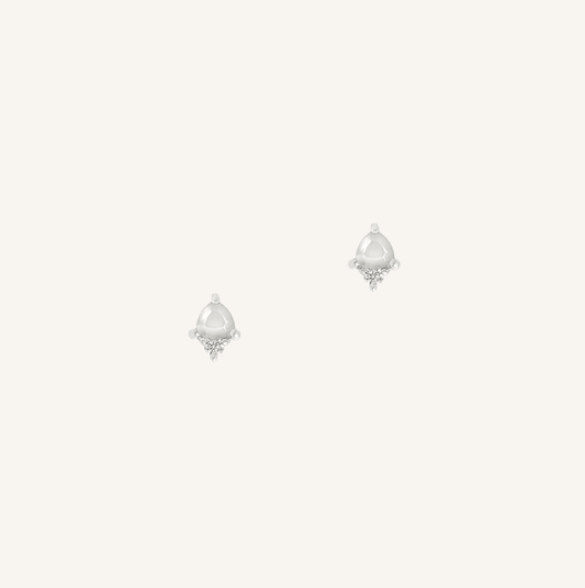 Pair of silver earrings with teardrop-shaped gemstones on a white background
