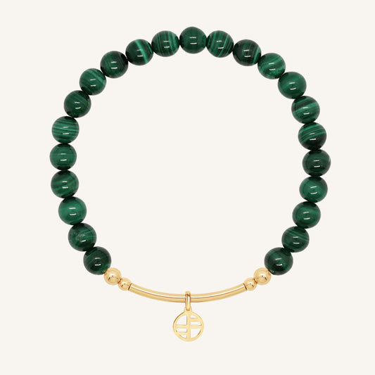 Green beaded bracelet with a gold bar on a white background
