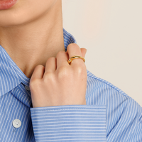 A gold-coloured ring with an irregular, smooth shape on a white background