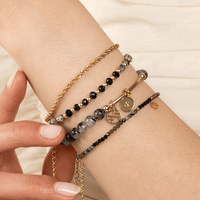 A gold-tone rope bracelet with a extender chain.