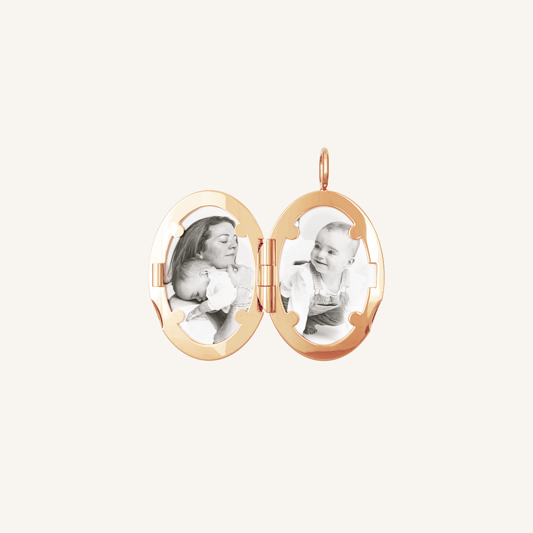 An oval-shaped photo locket with a rose metal tone, open to display two photographs