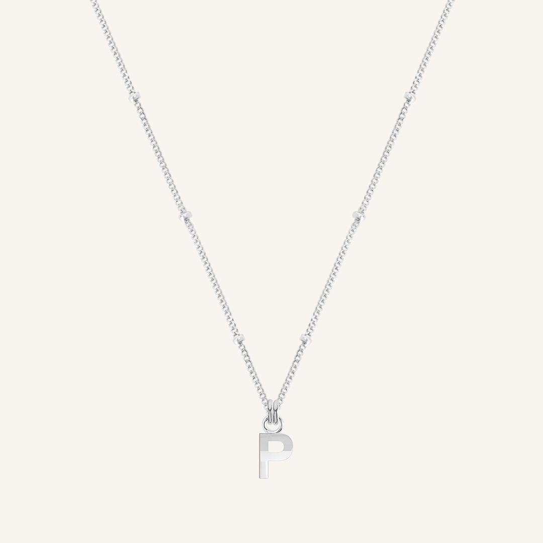 Silver necklace with a 'P' pendant on a light gray background
