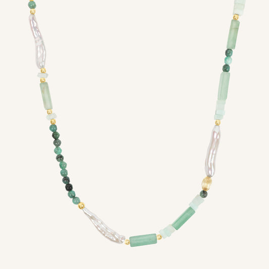 Necklace with green and white beads on a white background