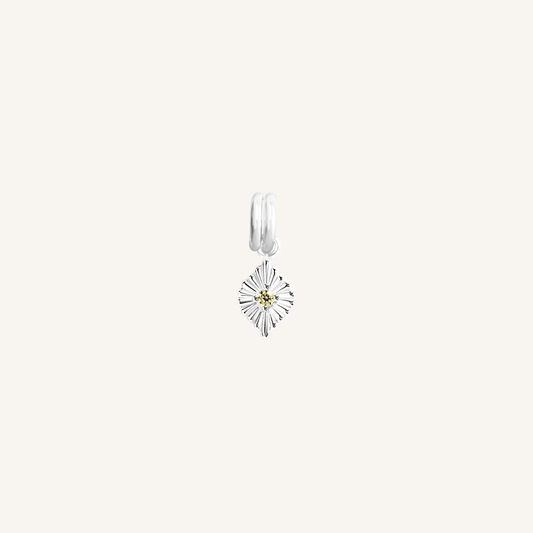 A silver birthstone charm with a peridot cubic zirconia representing the month of August.