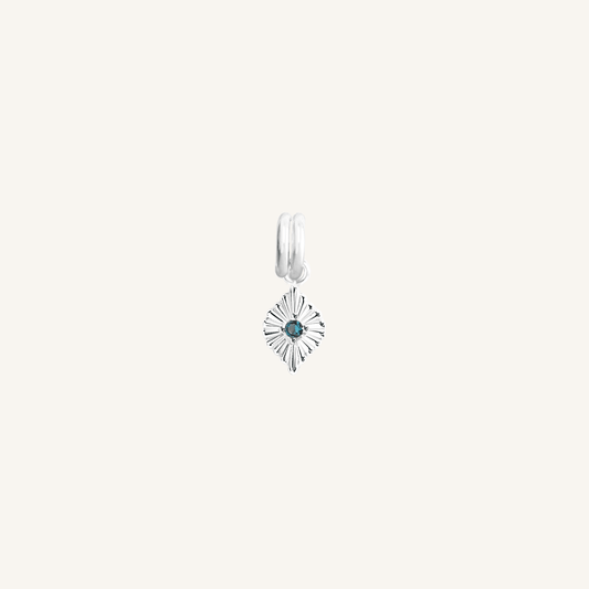A silver-colored birthstone charm with a central blue cubic zirconia, representing September