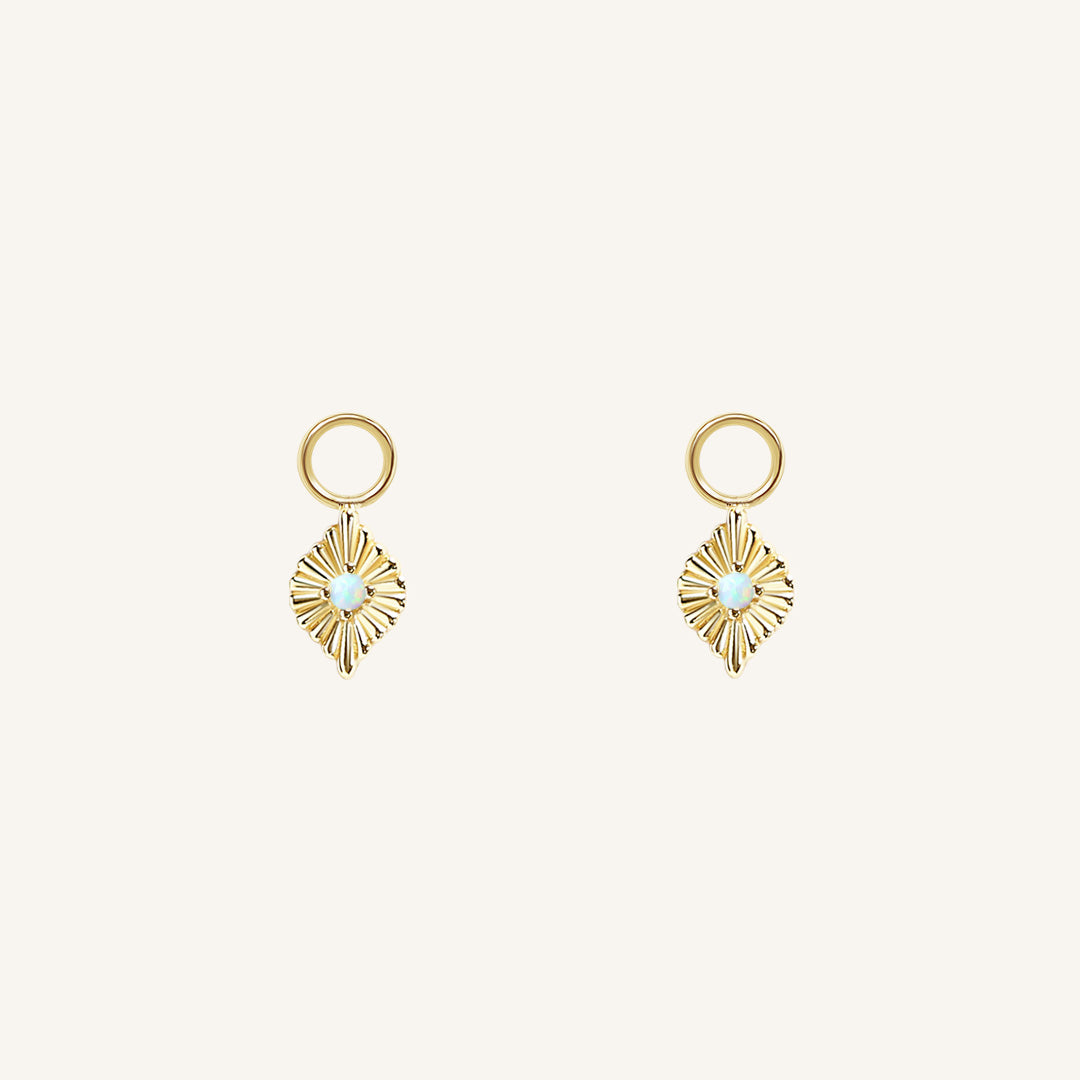 A pair of gold diamond shaped hoop charms featuring a faux opal 