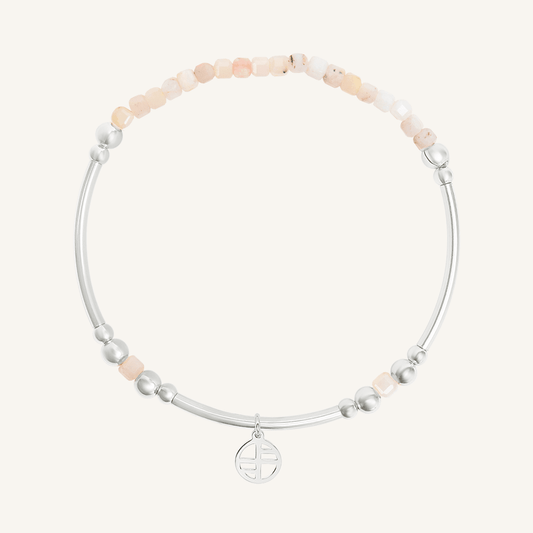 Bracelet with pink and silver beads on a white background