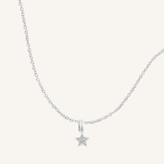 A silver necklace featuring a star-shaped charm pendant with cubic zirconias in the centre.
