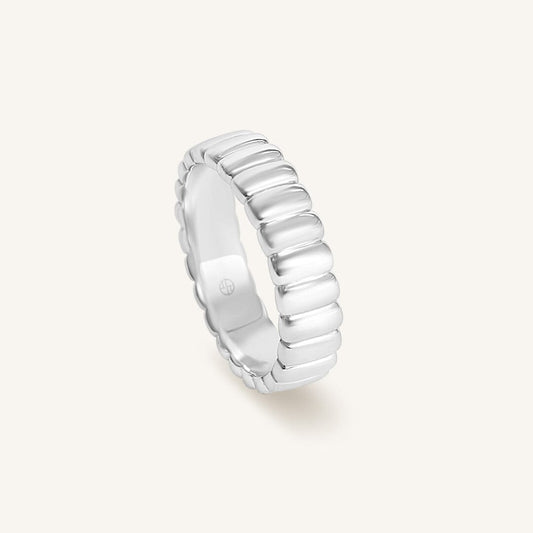 Silver ring with a textured band on a white background