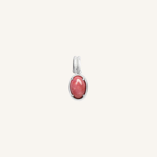 Silver charm with a pink gemstone on a white background