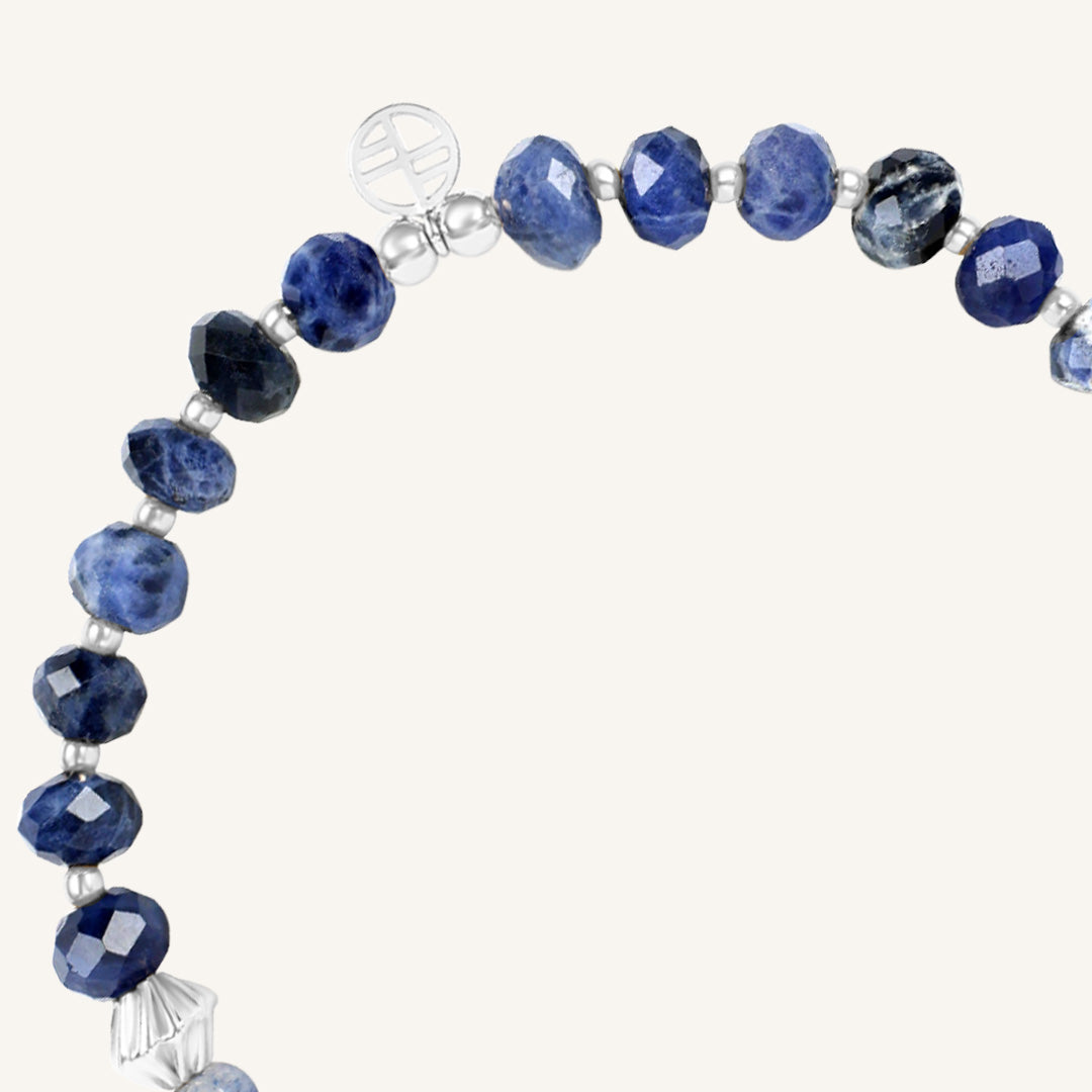 Bracelet with blue beads and silver accents on a white background