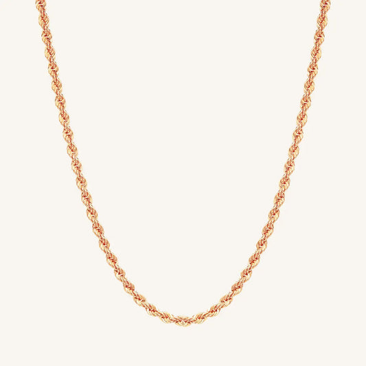 A rose rope chain necklace on a plain background.