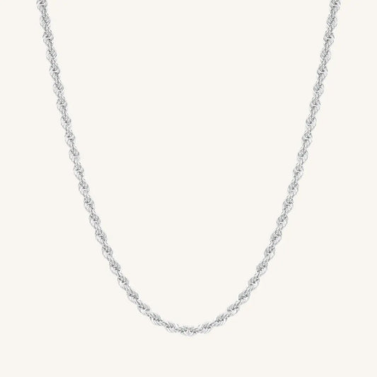 A silver rope chain necklace on a plain background.