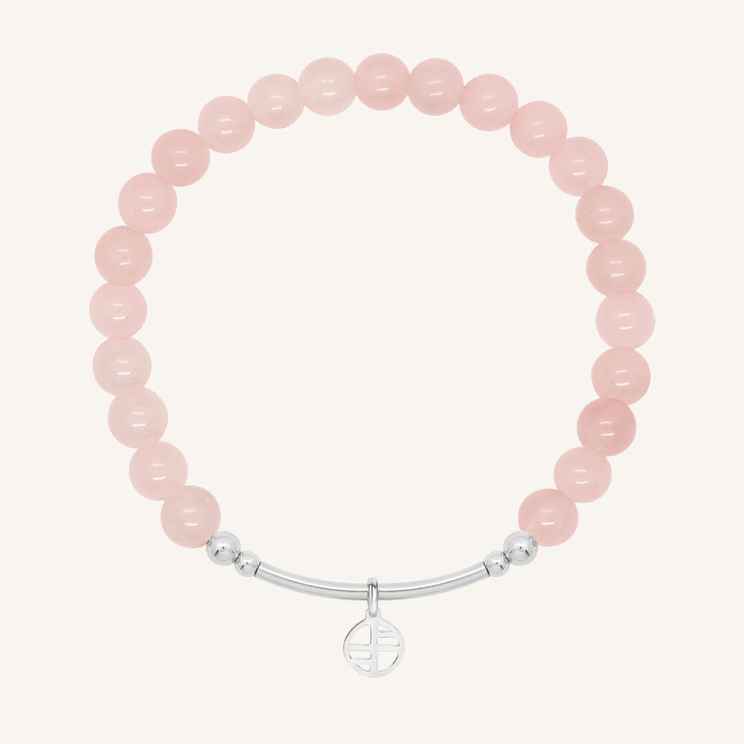 Pink beaded bracelet with a silver clasp on a white background