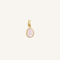 a gold charm with a tear-drop shaped rose quartz stone 