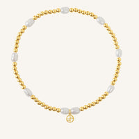 A coloured stretchy anklet with freshwater pearls and a small gold charm, displayed against a white background.