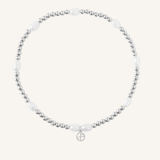 A coloured stretchy anklet with freshwater pearls and a small gold charm, displayed against a white background.