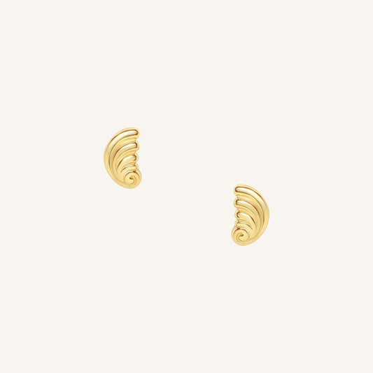 Pair of gold spiral earrings on a white background