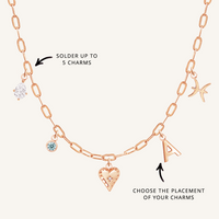 A rose chain necklace with paperclip links and multiple charms, showcasing where to solder charms and the option to choose the placement of the charms.