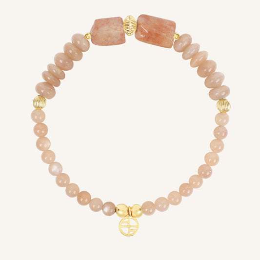 Bracelet with pink beads and gold accents on a white background