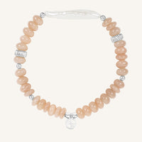 Bracelet with pink beads and silver accents on a white background