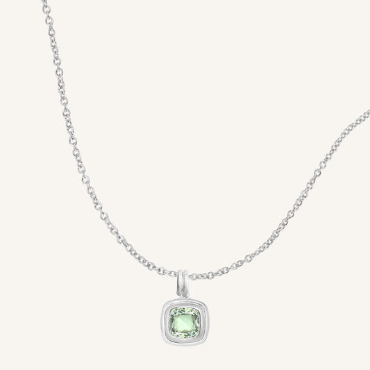 Necklace with a green gemstone pendant on a white background
