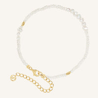 Pearl anklet with gold clasp on a white background