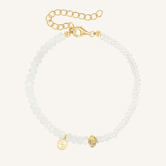 Bracelet with gold beads and clasp on a white background