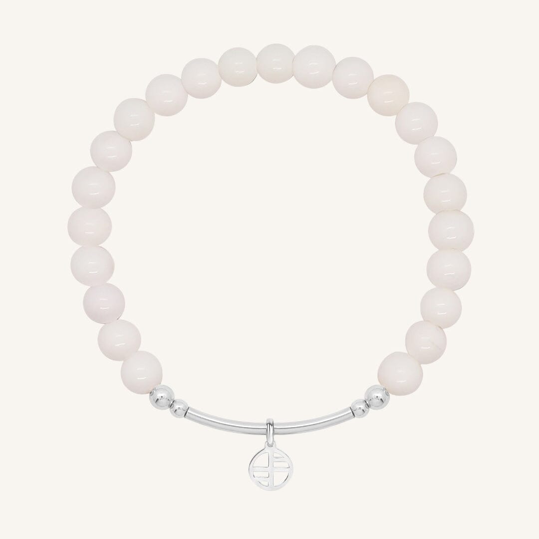 White beaded bracelet with a silver clasp on a white background