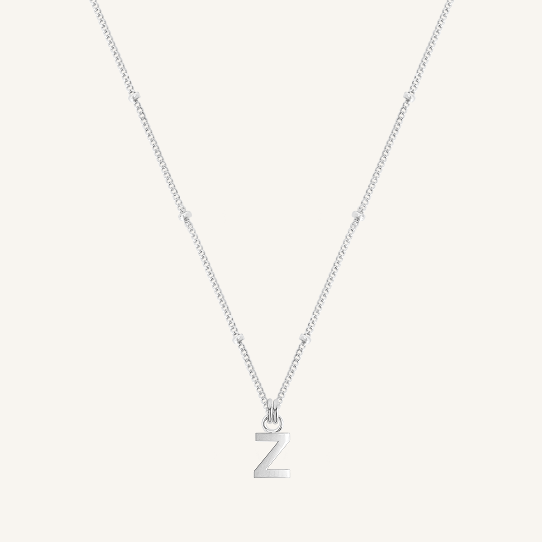 Silver necklace with a 'Z' pendant on a light gray background