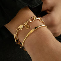 A chunky link style bracelet in silver tone, featuring a clasp closure.