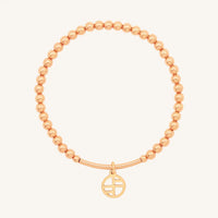 A rose-tone charm bracelet with 4mm beads and a charm pendant hanging in the center.