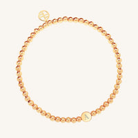 A rose bracelet with a beaded design and an engraveable bead