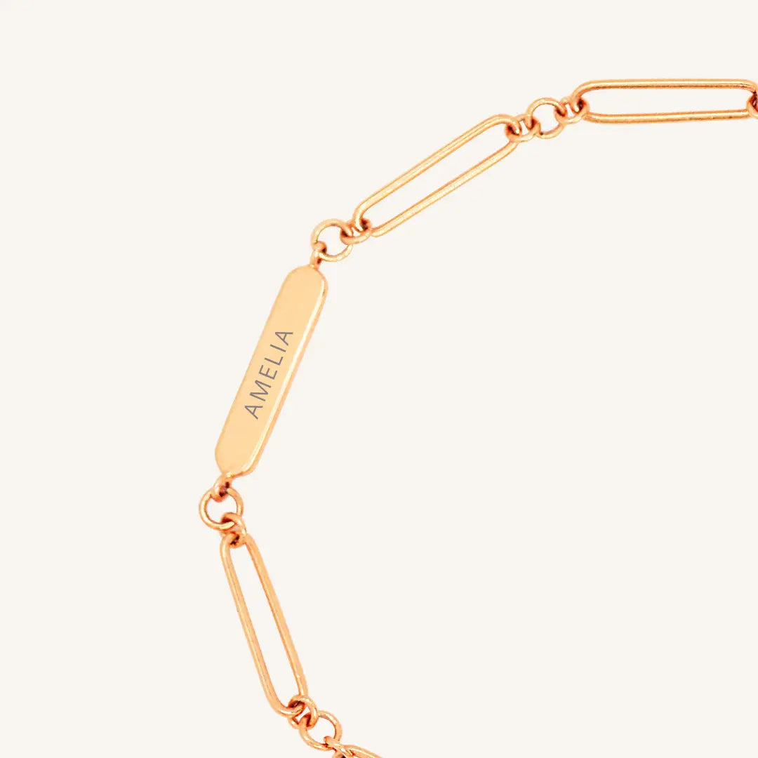 A rose chain bracelet with an adjustable fastening design and an engraveable panel.